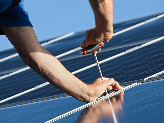 Person bringt Solarmodul an
